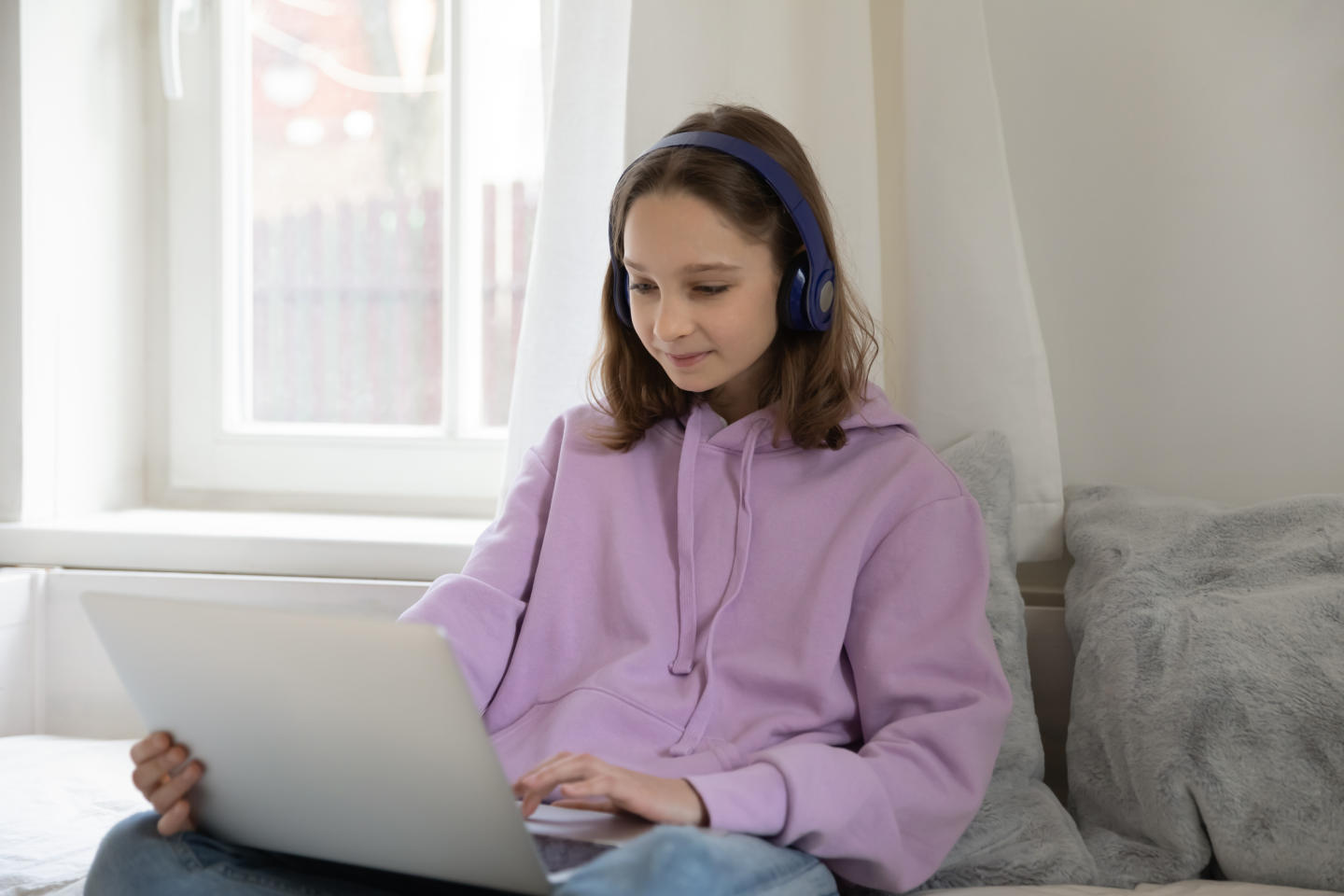 Female teenager using a laptop.