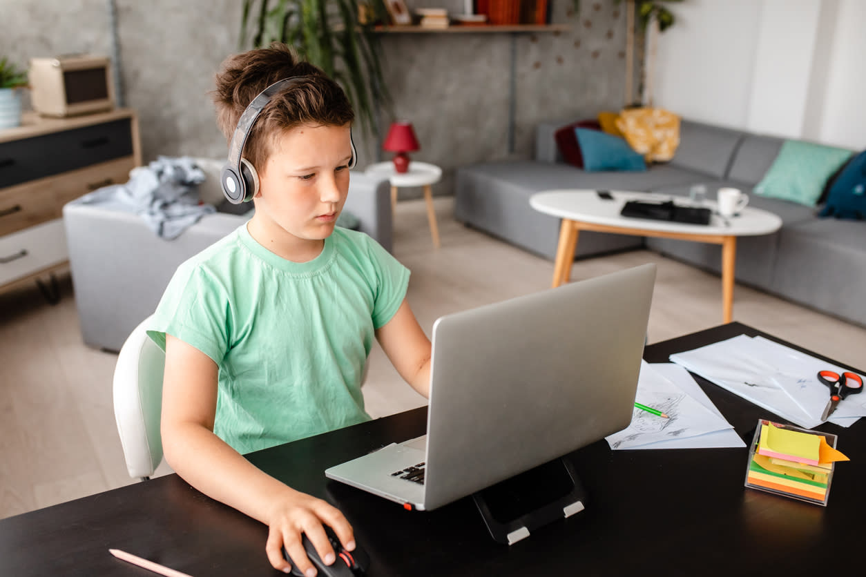 Child on a laptop wearing headphones