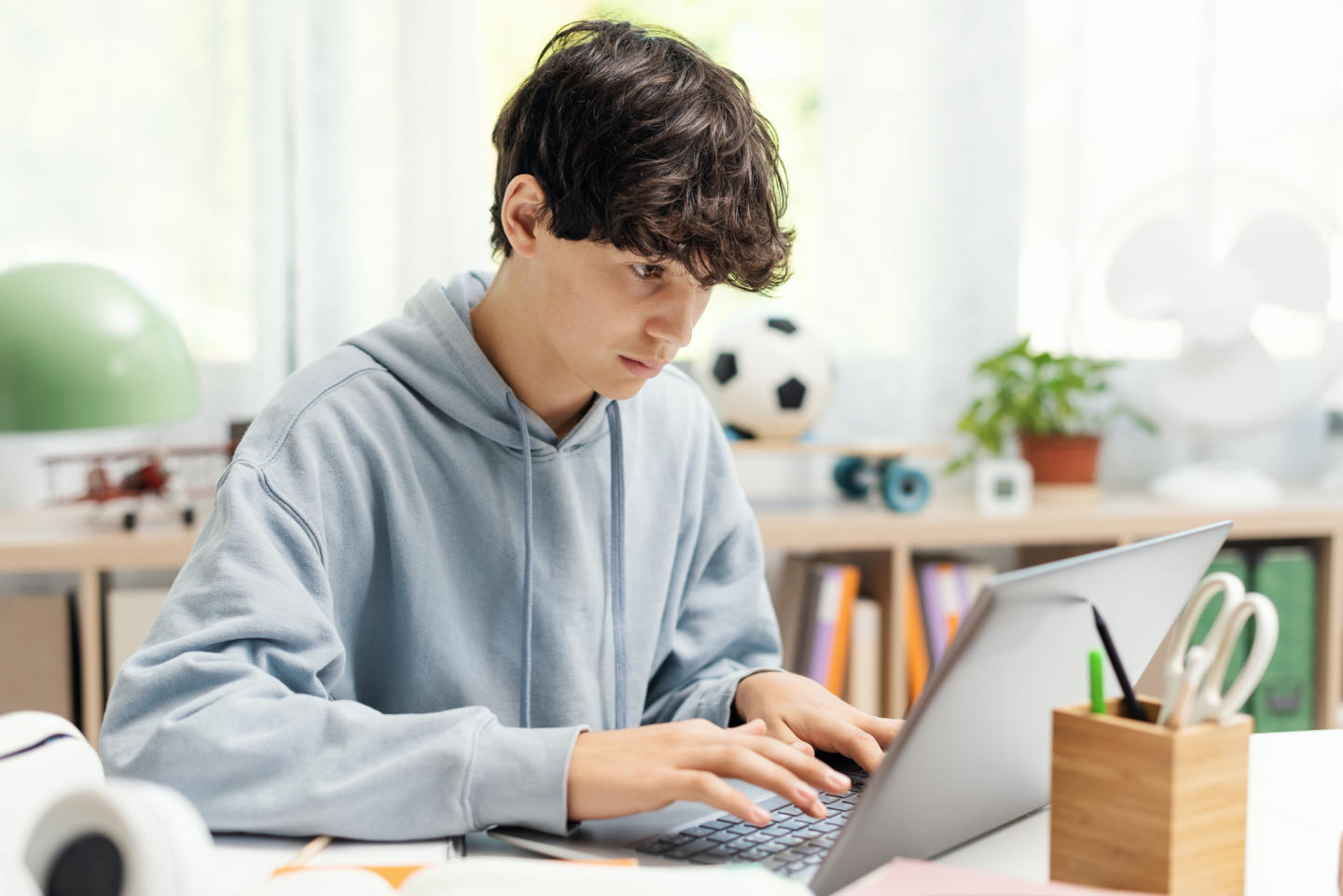 Teenager using a laptop