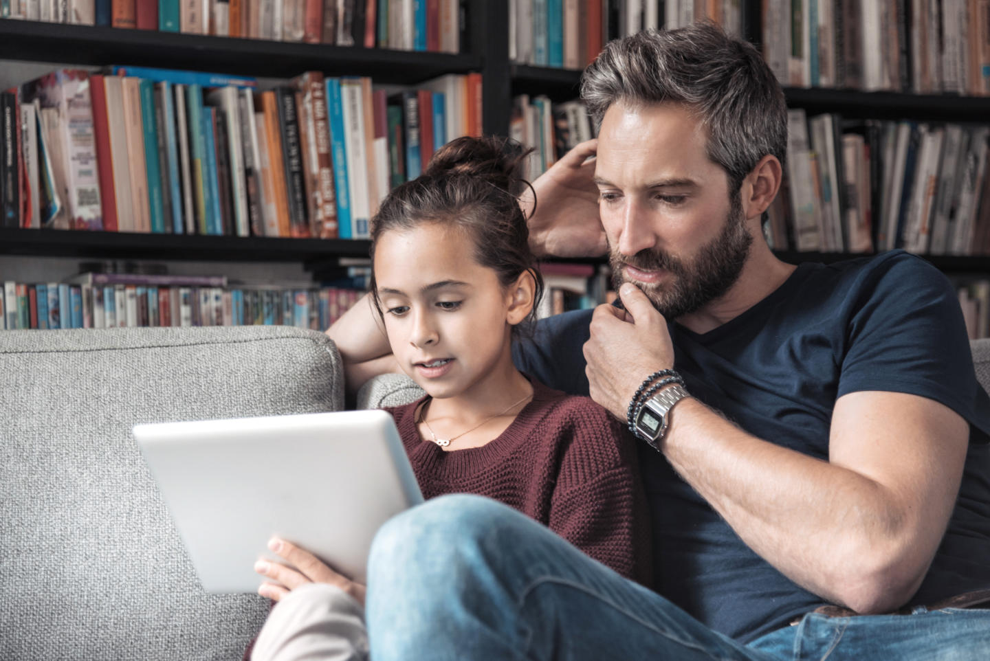 Father and daughter looking at tablet computer