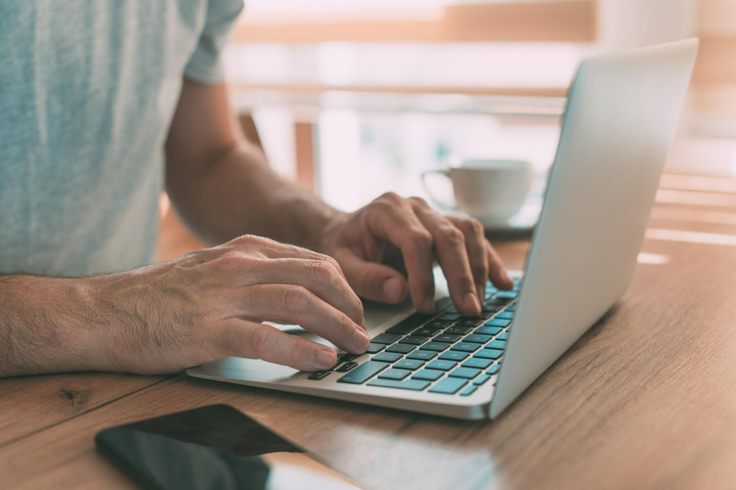 Adult hands typing on laptop