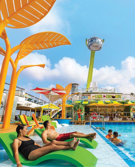 Family relaxing by the pool onboard Odyssey Of The Seas. Utopia Of The Seas.