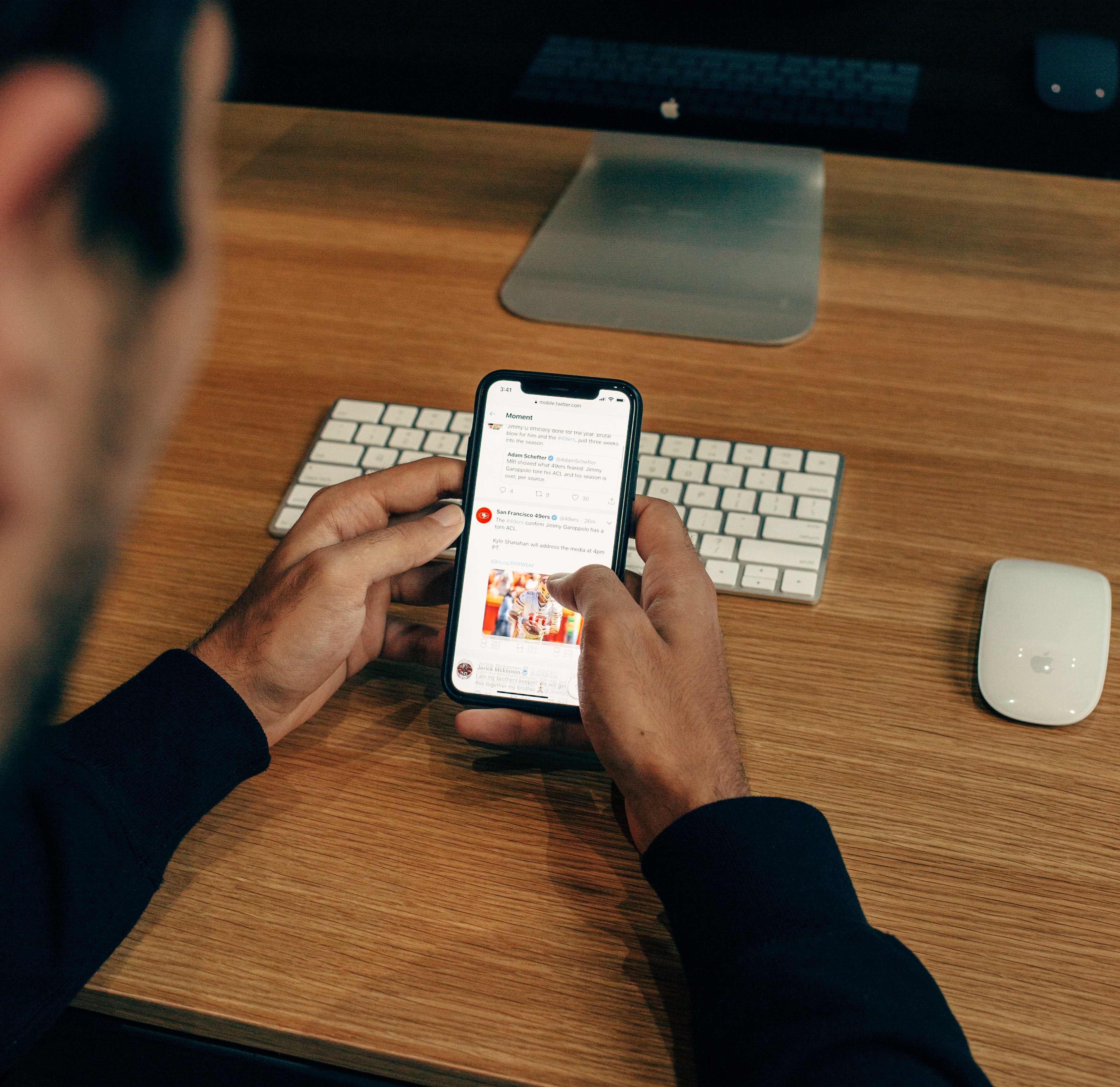 a man uses a smartphone to send text messages.