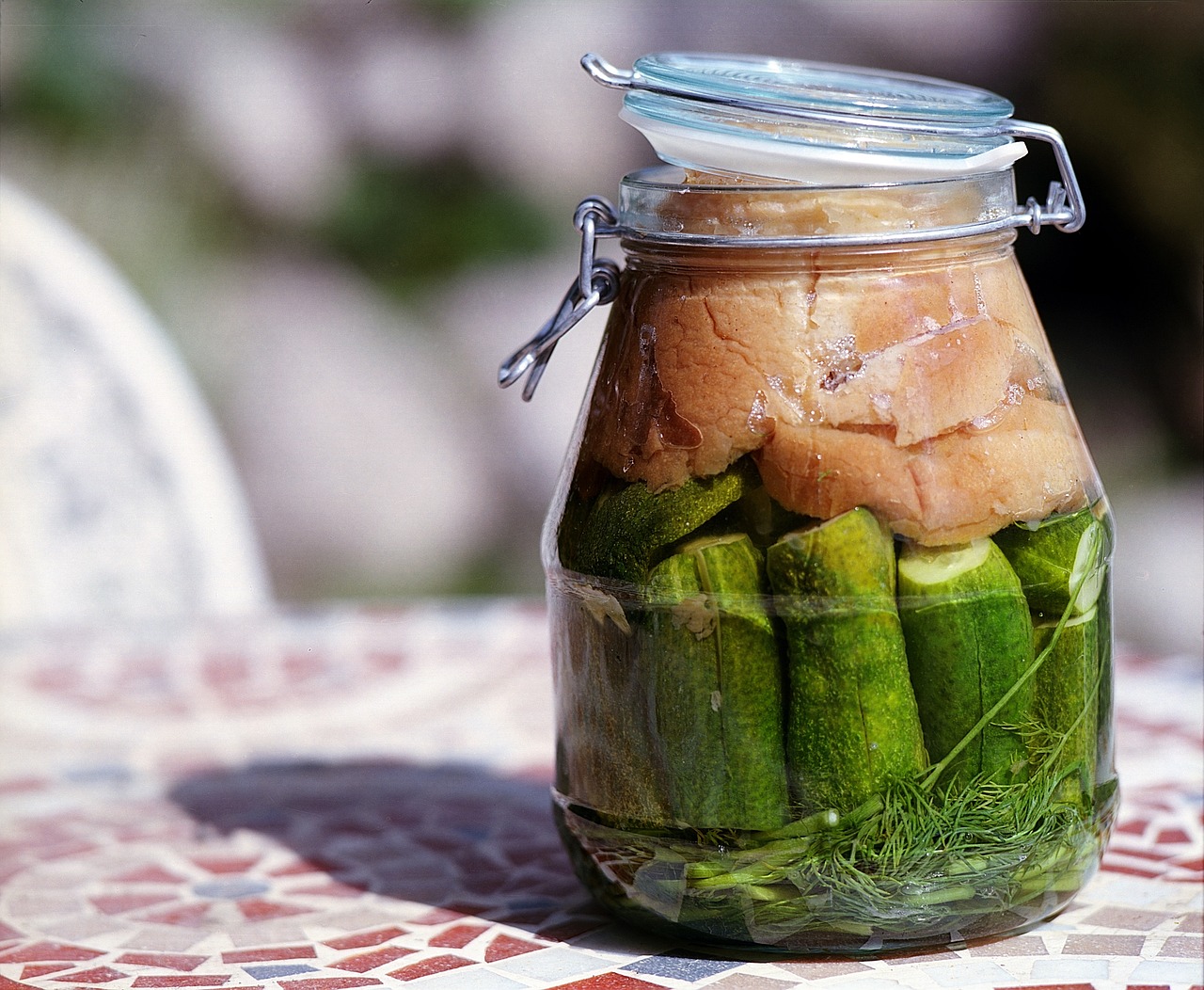 a jar of pickles on a table.