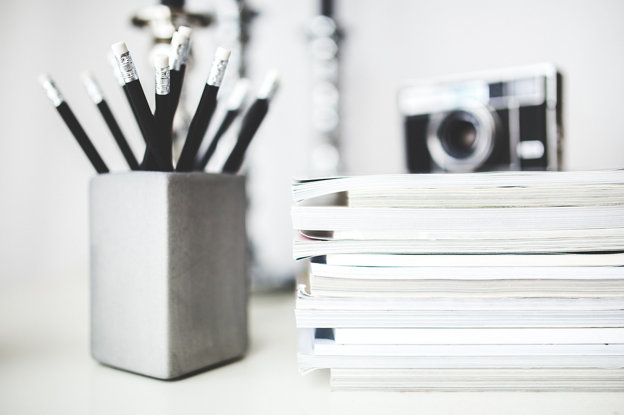 a stack of books on a desk.