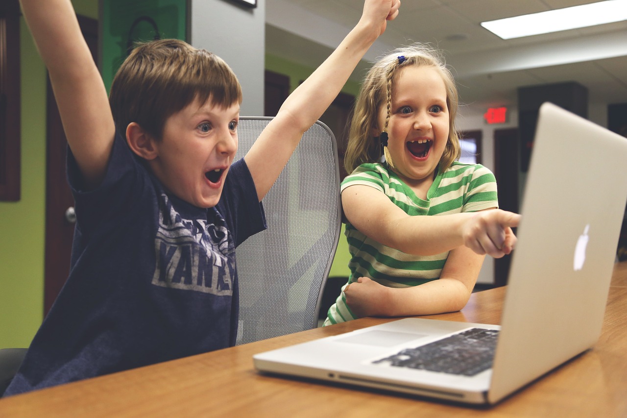 children using a laptop in the classroom.