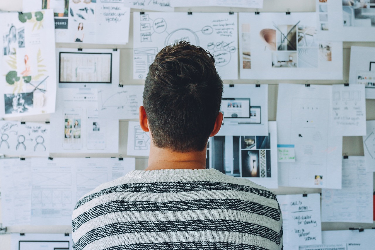 man looking at a blank wall.