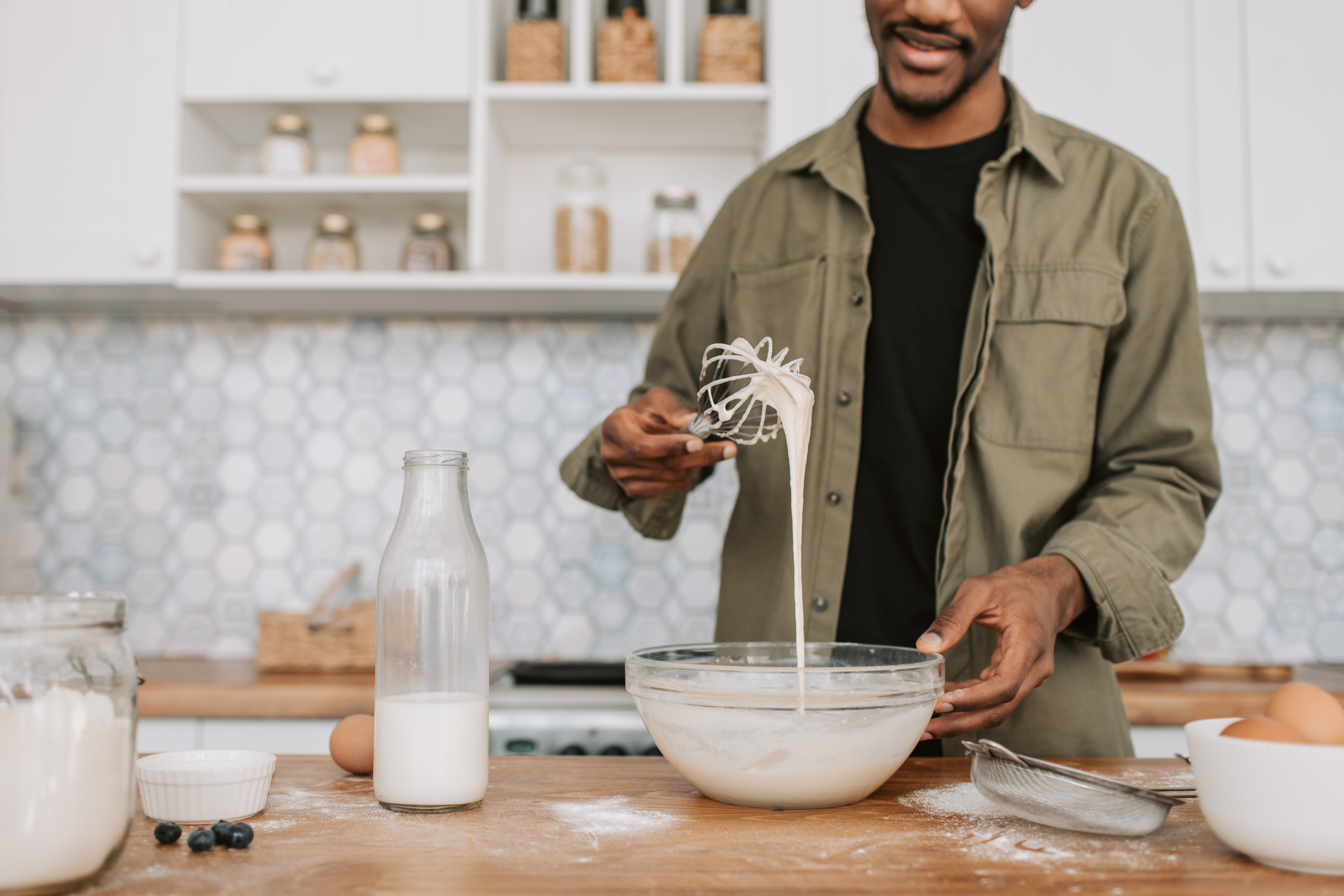 man mixing ingredients in a blender.