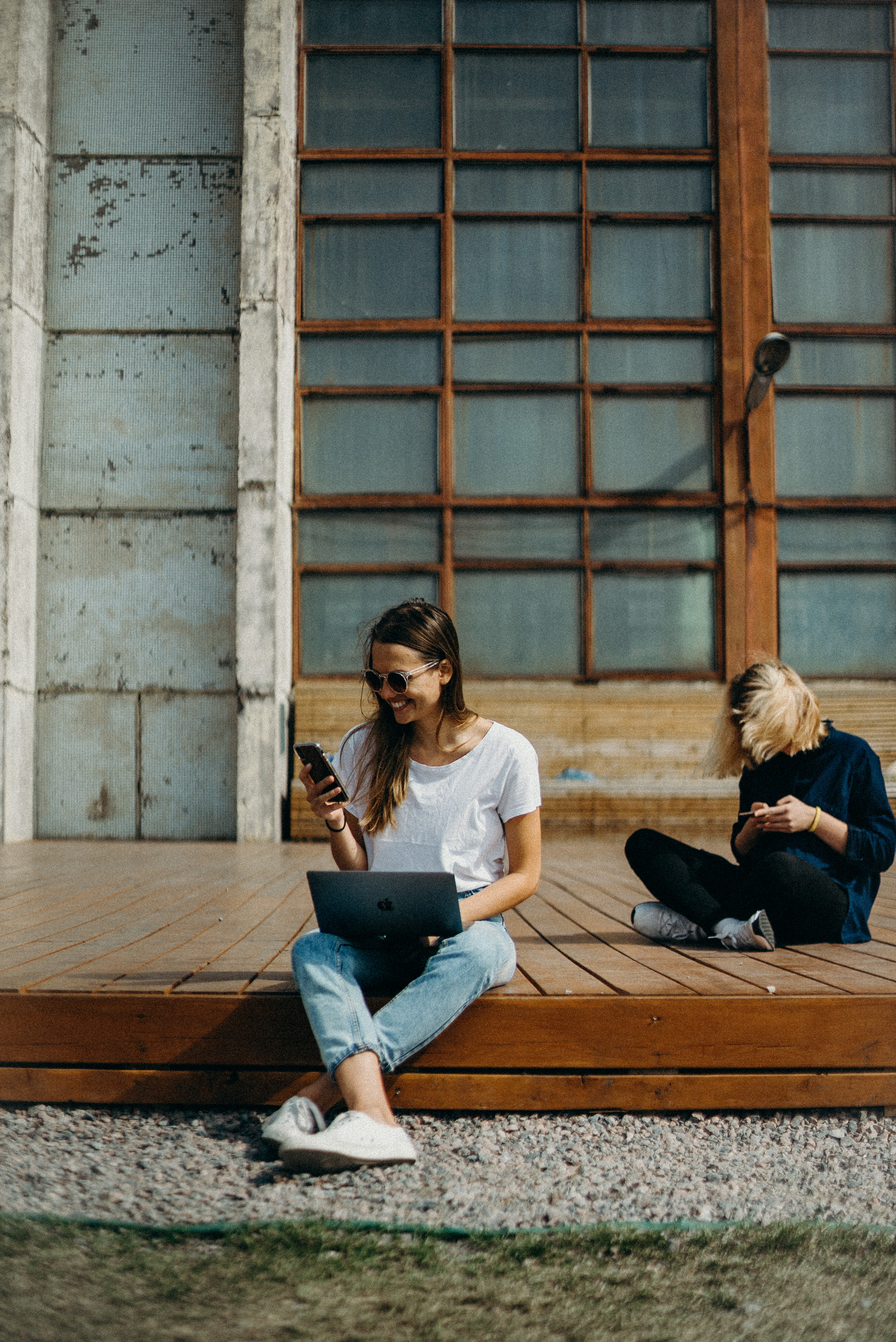 young woman sitting on the stairs and using tablet.