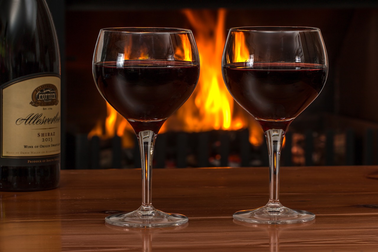 glasses of red wine on a wooden table.