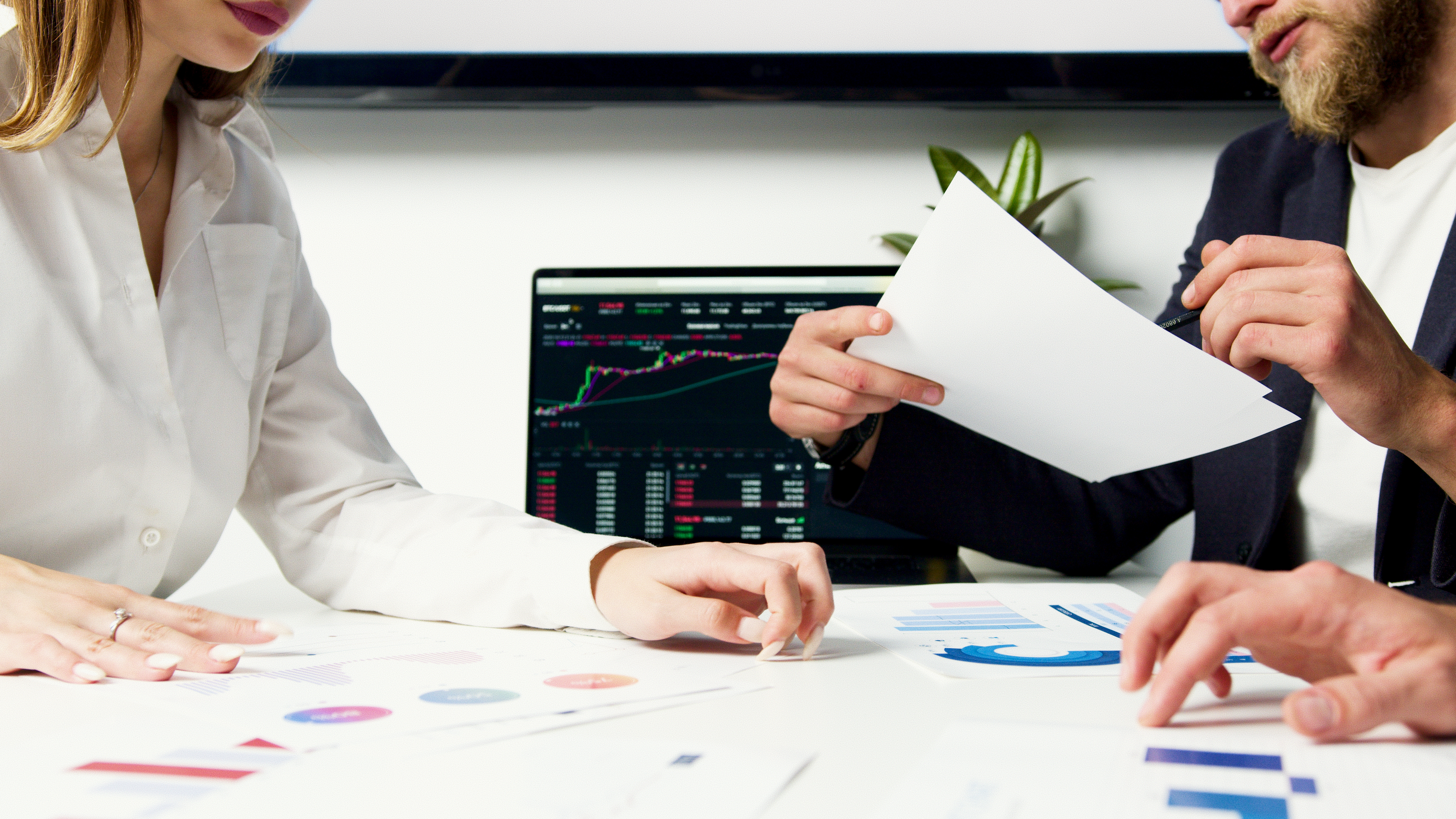 businessman sitting at desk in the office and looking at charts.