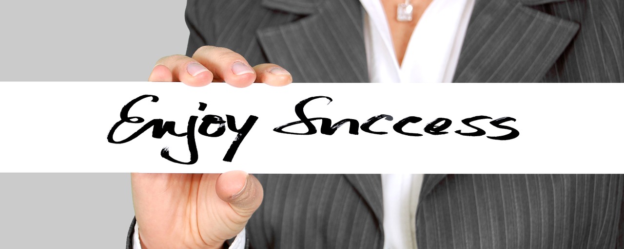 businessman writing success with a white chalk.