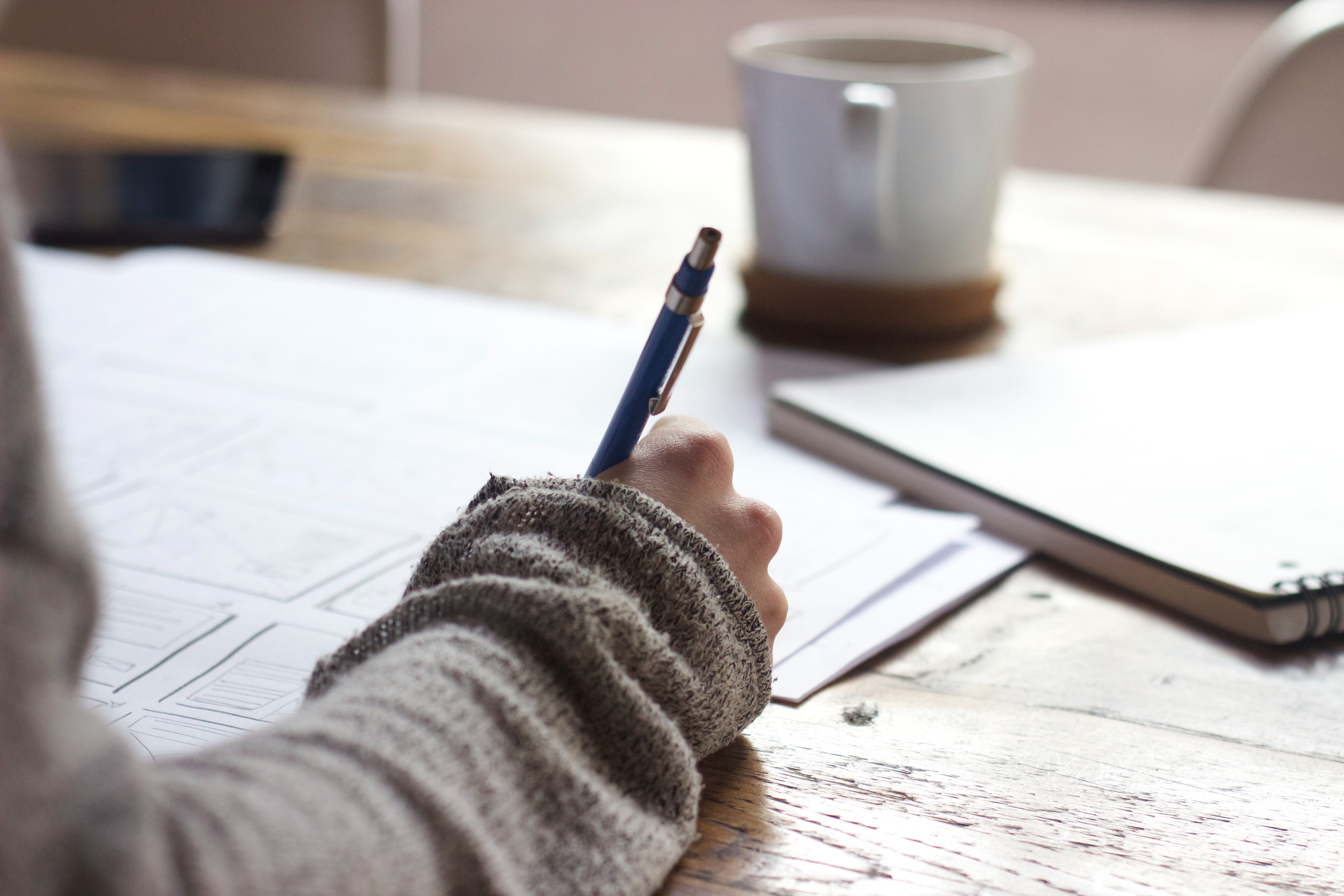 woman writing on a notebook.