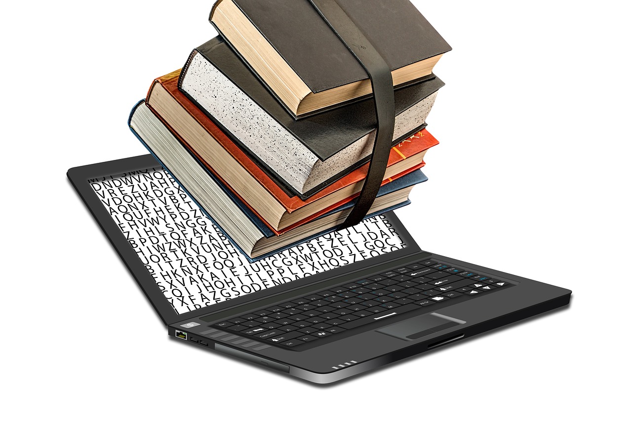 books and laptop on a white background.