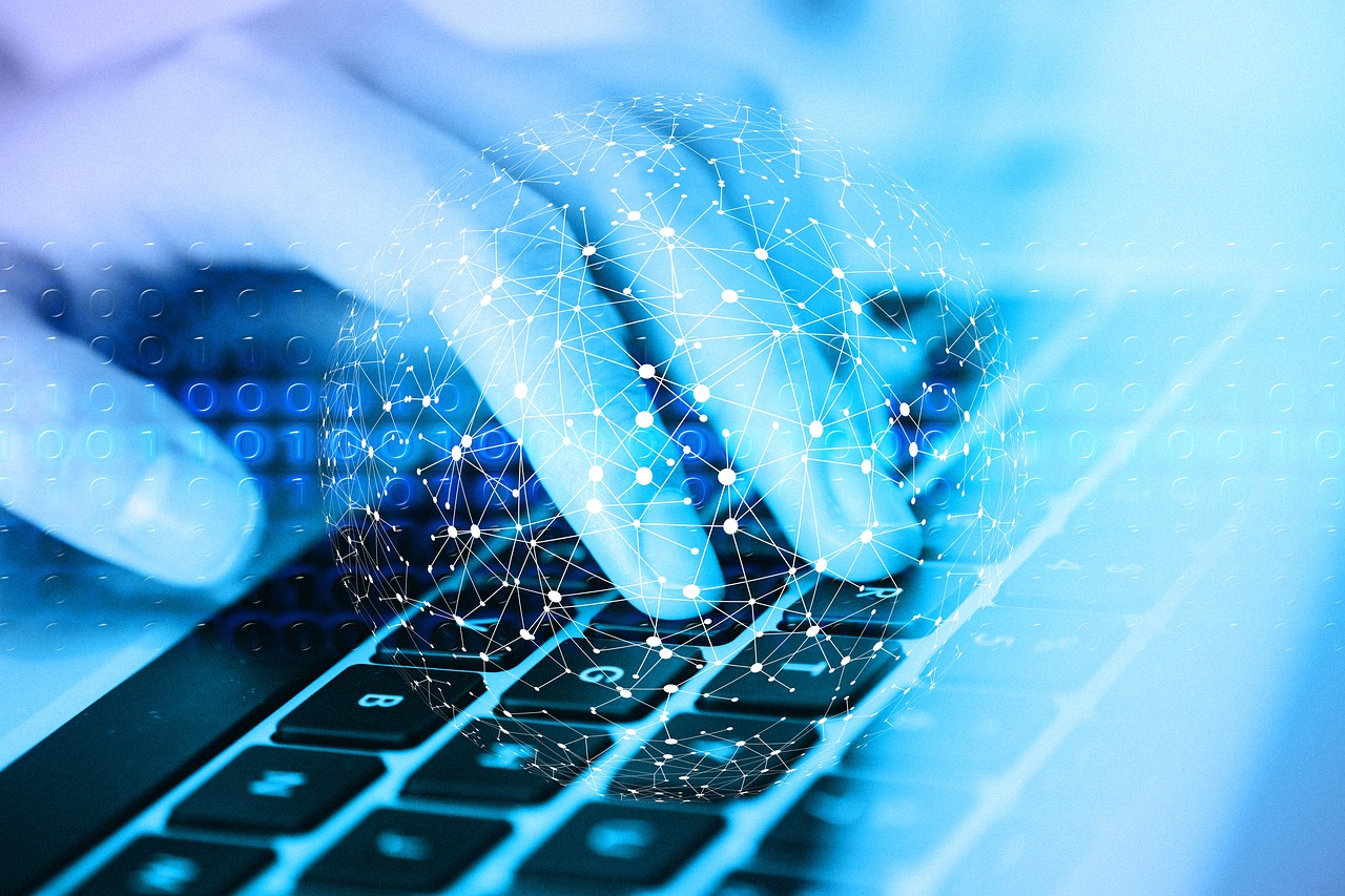 hands typing on a laptop keyboard.