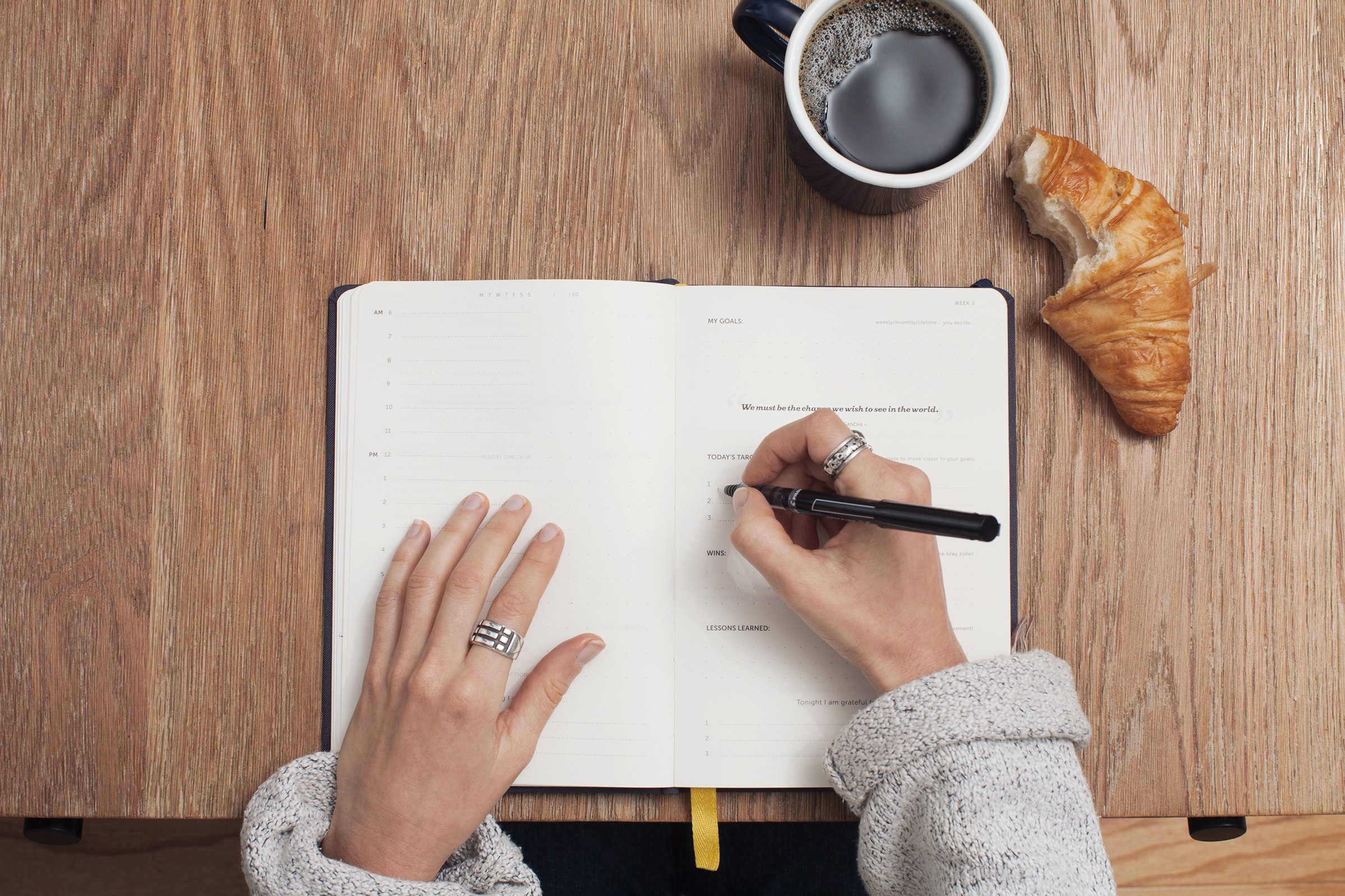 woman's hand writing on a notebook.