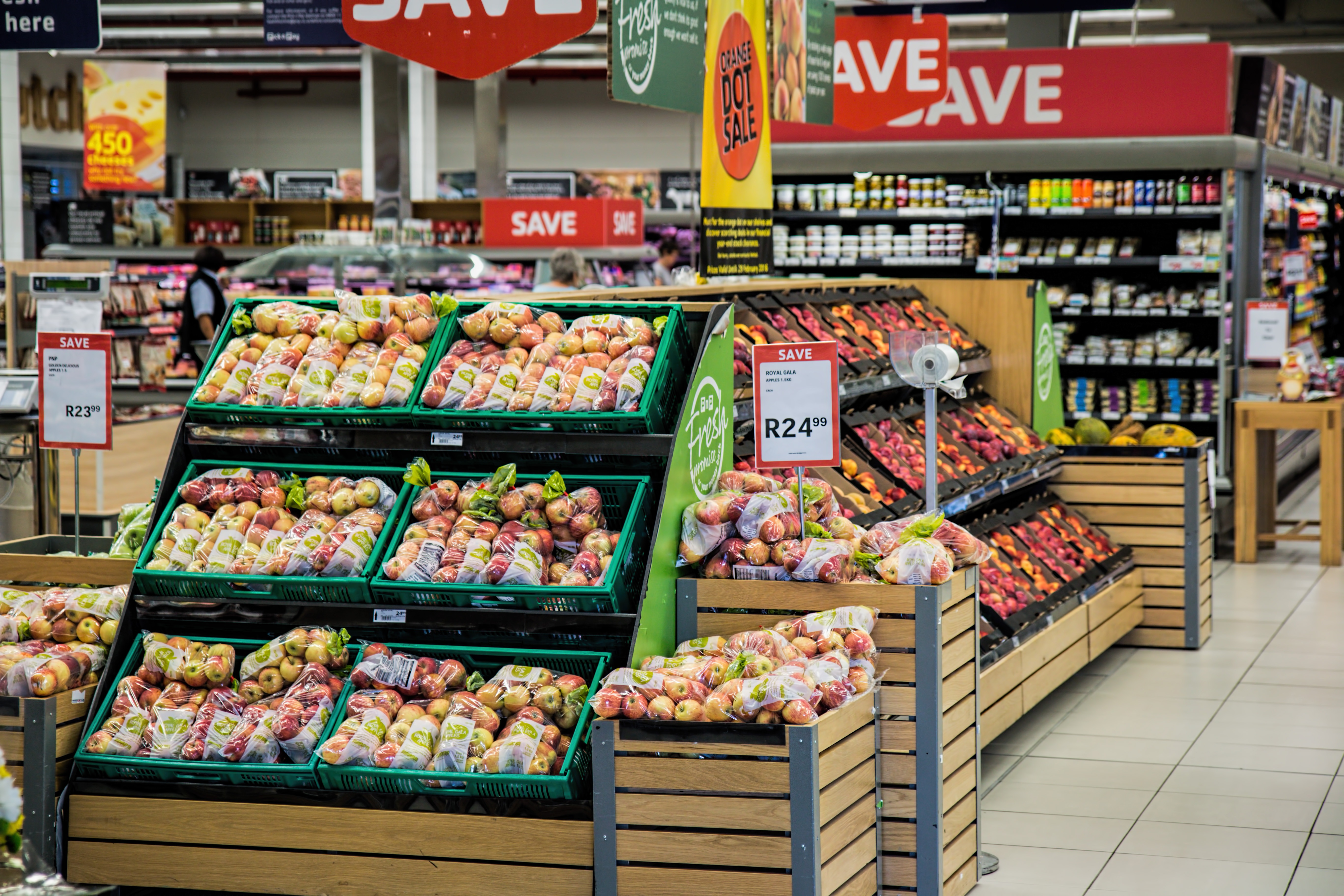 fresh fruit and vegetables on display in a supermarket.