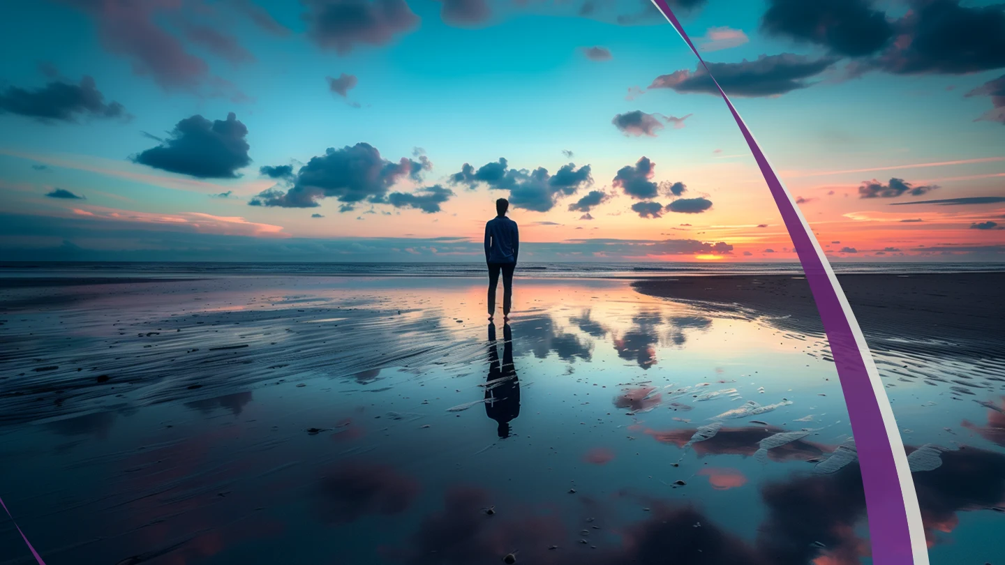 Uma pessoa na praia olhando o horizonte