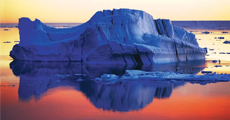 Sunset over icebergs, Antarctica.