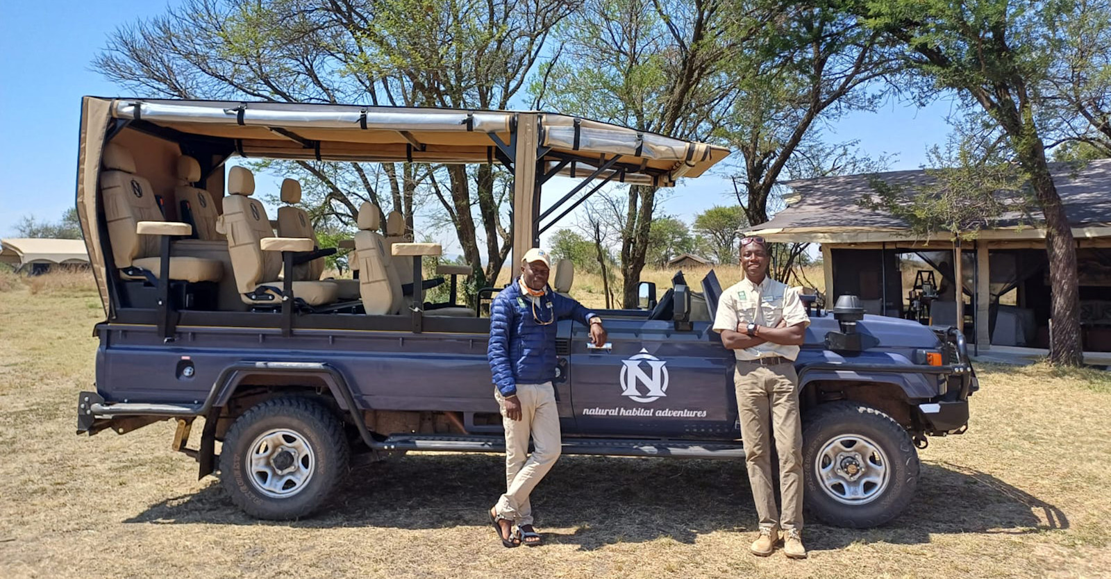 Safari trucks at Nat Hab's Migration Camp—Serengeti North