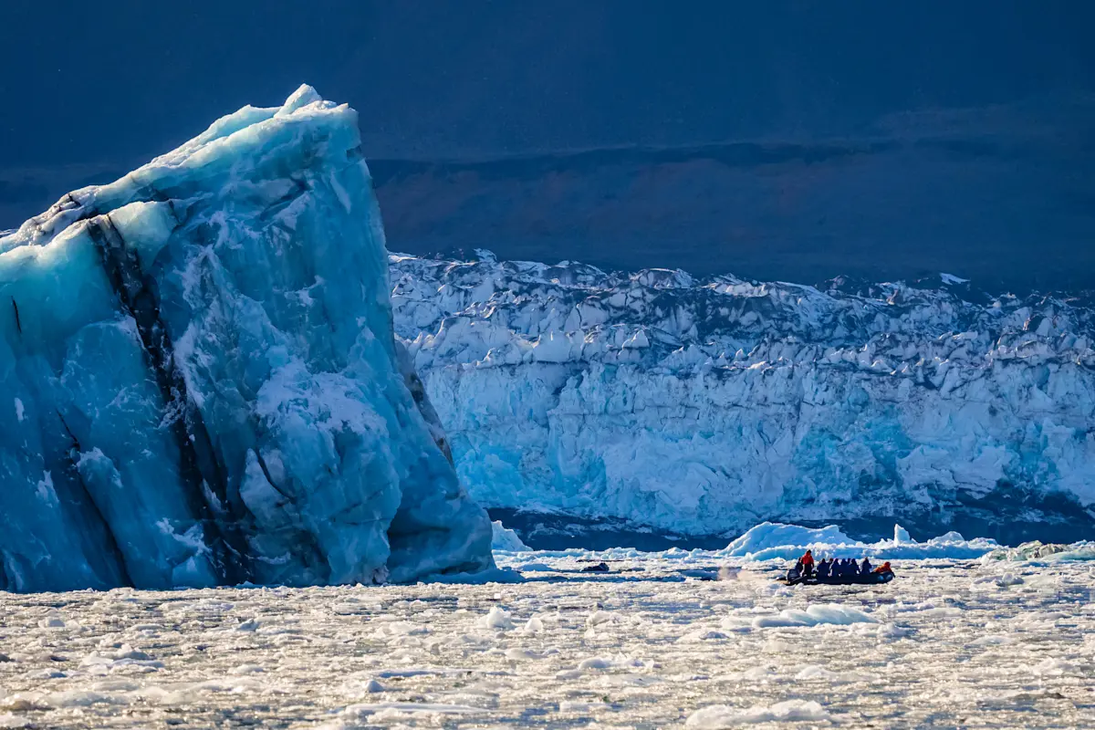 Guests on Zodiac cruise, Romer Fjord, Greenland.