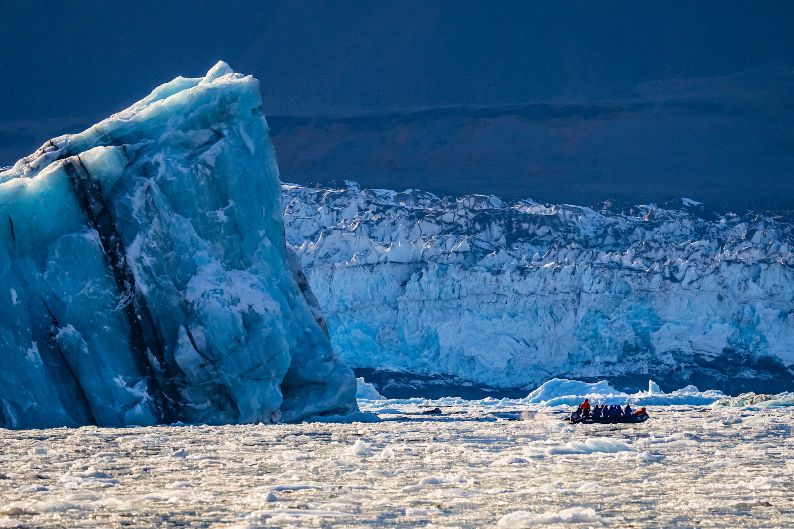 Guests on Zodiac cruise, Romer Fjord, Greenland.