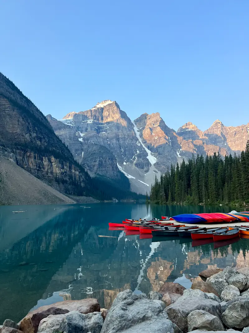 Admiring the stunning Moraine Lake in Alberta, Canada.