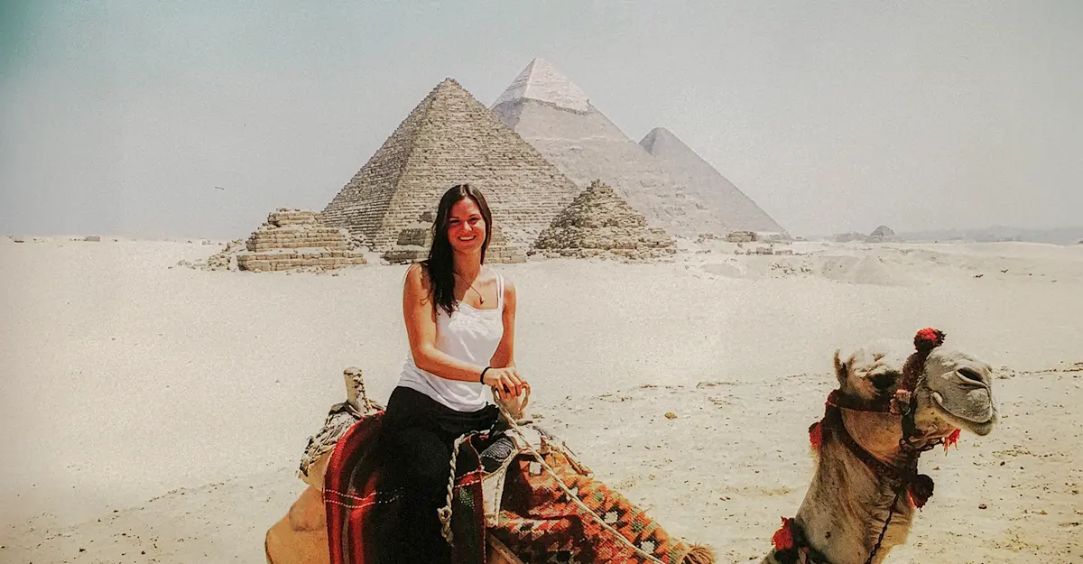 Riding through desert history on camelback at the Pyramids of Giza, Egypt.