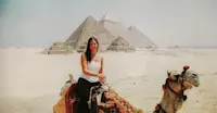 Riding through desert history on camelback at the Pyramids of Giza, Egypt.