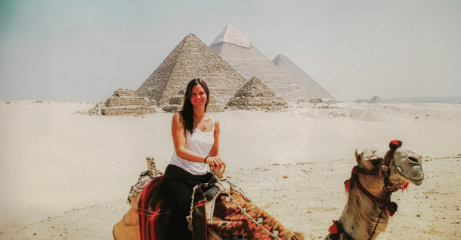 Riding through desert history on camelback at the Pyramids of Giza, Egypt.