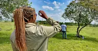 Earthwatch Expeditions guest performing fieldwork, Maasai Mara, Kenya.
