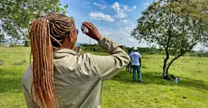Earthwatch Expeditions guest performing fieldwork, Maasai Mara, Kenya.