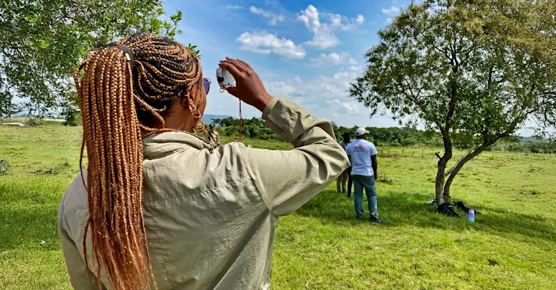 Earthwatch guest performing fieldwork, Maasai Mara, Kenya.