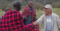 Maasai and guest at Nat Hab’s Mara East Camp, Private Mara Conservancy, Kenya.
