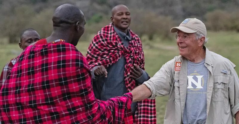 Maasai and guest at Nat Hab’s Mara East Camp, Private Mara Conservancy, Kenya.