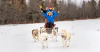 Enjoying dog sledding while on Polar Bears trip in Canada.