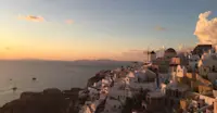 Domes, white walls, and endless sea, Santorini, Greece.
