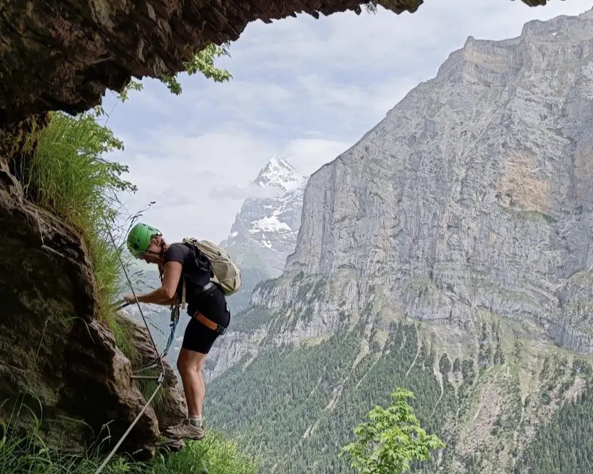 Rock climbing a via ferrata in the Swiss Alps, Switzerland.