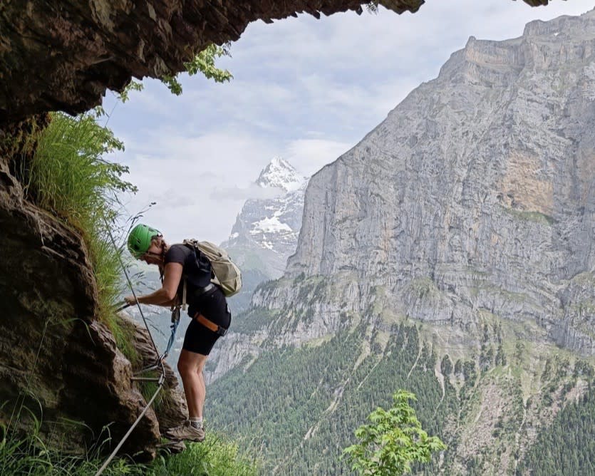 Rock climbing a via ferrata in the Swiss Alps, Switzerland.