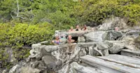 Nat Hab guests enjoy the natural hot spring at Hotspring Island, British Columbia.