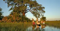 Nat Hab guests in mokoros, Okavango Delta, Botswana.