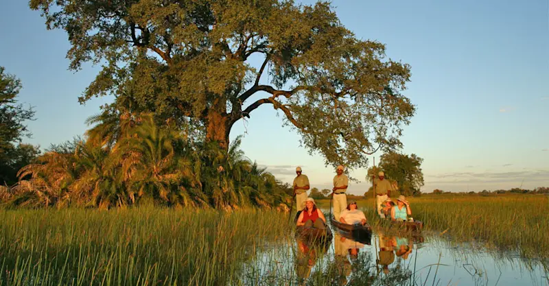 Nat Hab guests in mokoros, Okavango Delta, Botswana.