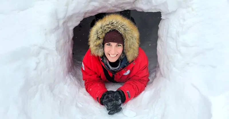 Nat Hab Expedition Leader inside quinzee, Churchill, Manitoba.