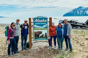 Installing the sign at Bear Camp, Alaska.