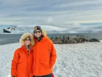 Posing with penguins at Mikkelsen Harbor, Antarctica.