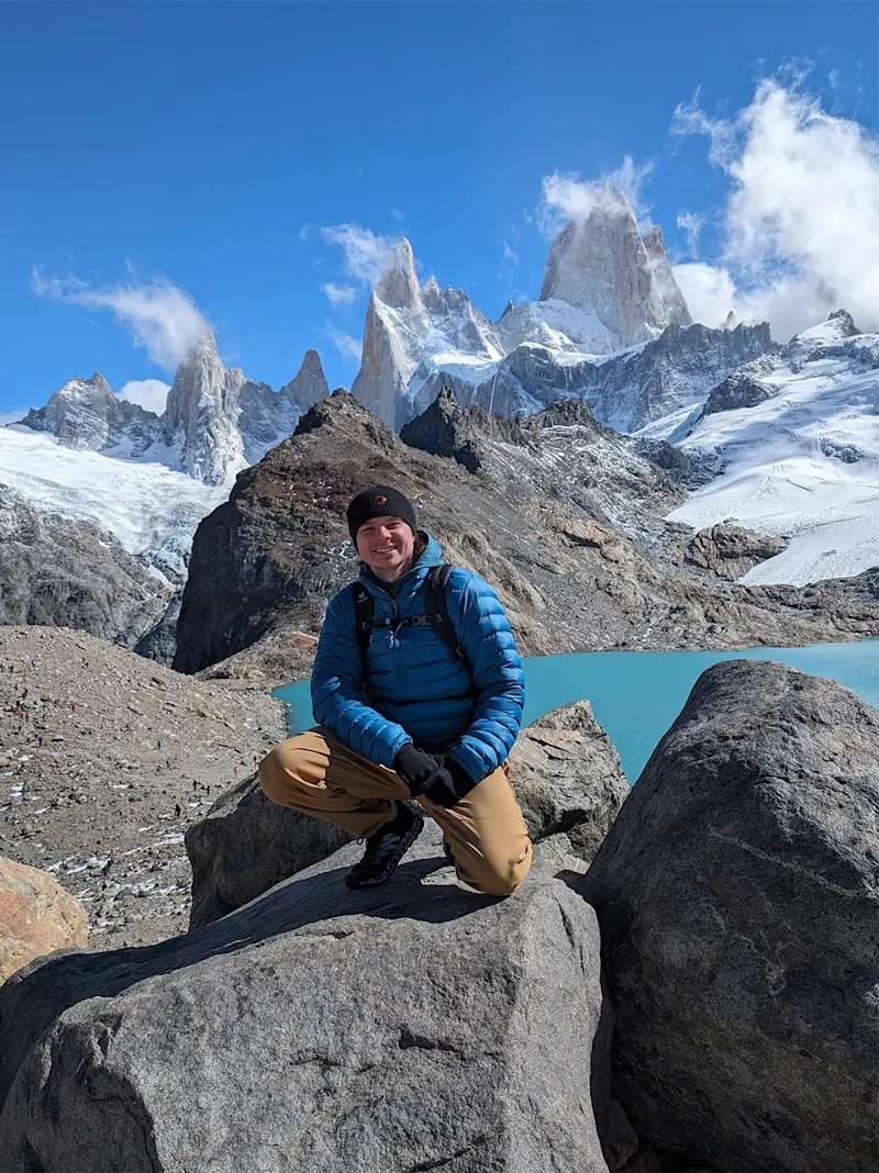 Solo hiking in Patagonia, posing in front of the iconic Fitz Roy mountain in Patagonia.