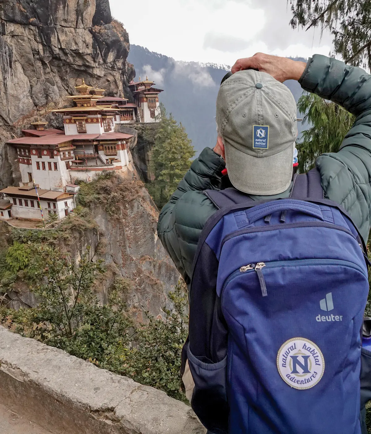 Nat Hab guest photographing Paro Taktsang Monastery (Tiger's Nest), Upper Paro Valley, Bhutan.