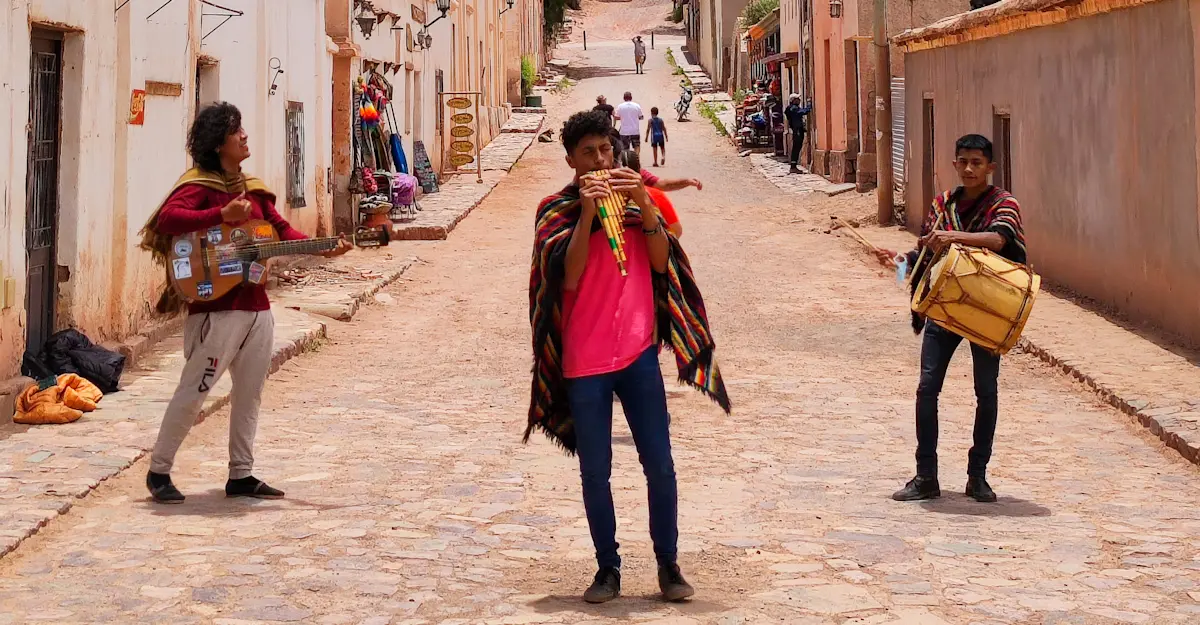 Trio of street musicians playing traditional Andean instruments, Tilcara, Argentina.