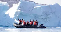 Nat Hab guests on zodiac ride, Sermilik Fjord, Greenland.
