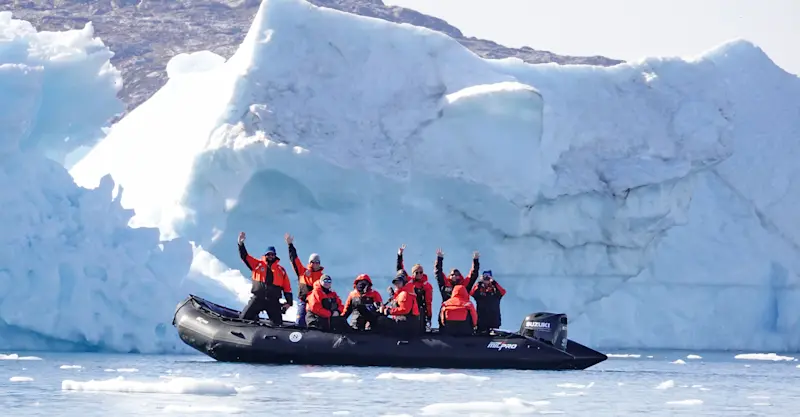 Nat Hab guests on zodiac ride, Sermilik Fjord, Greenland.